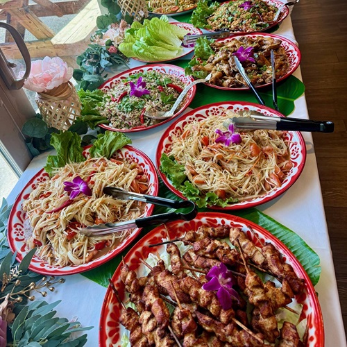 Catering table of Loa dishes at a party from Khao Niew
